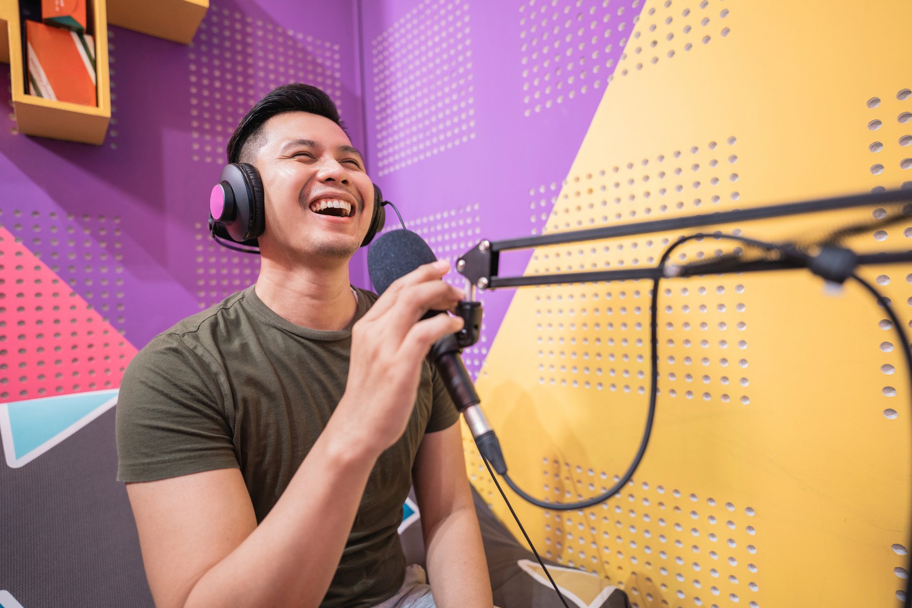 Happy Asian Man Is Recording a Podcast in His Studio